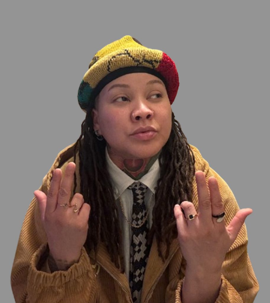 Lyssa True Poet portrait wearing yellow hat and brown coat